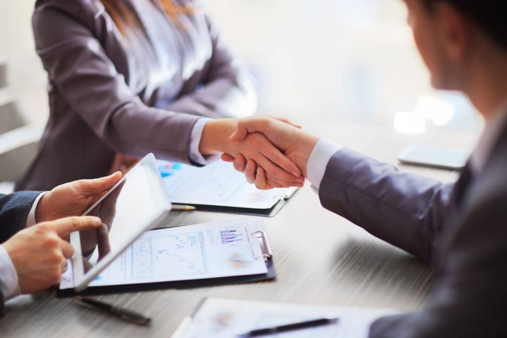A group of professionals having a discussion in a corporate setting, symbolizing corporate migration